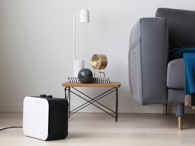 Compact fan heater in a living space on the ground.
