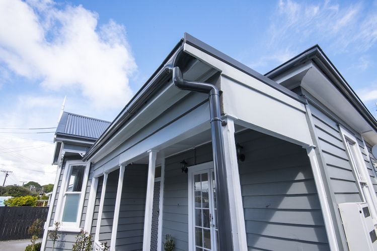 House with dark grey painted PVC drain pipe
