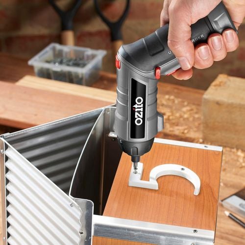 Small Ozito driver tool is tightening a screw to affix a number '5' to a letter box