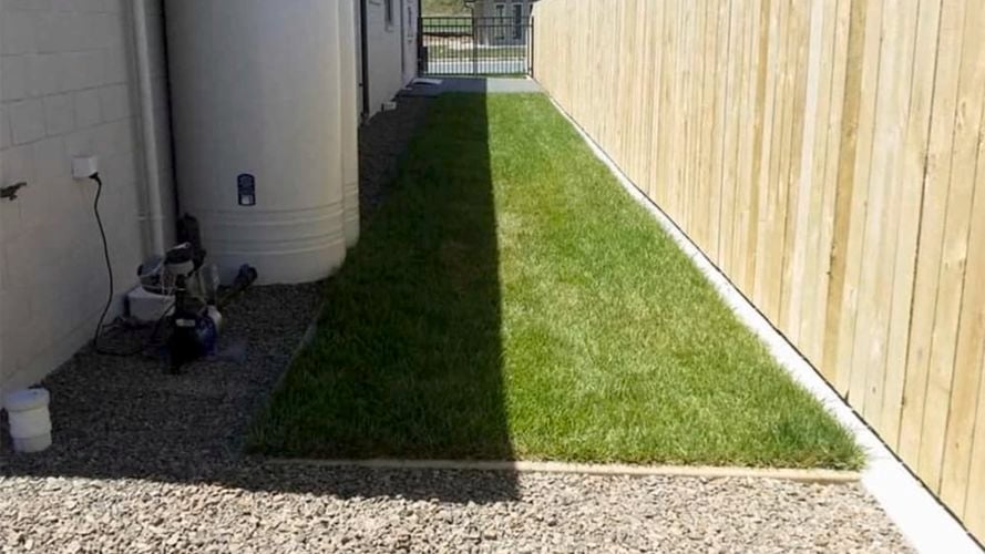 Grass grade paving used beside house to reinforce grass