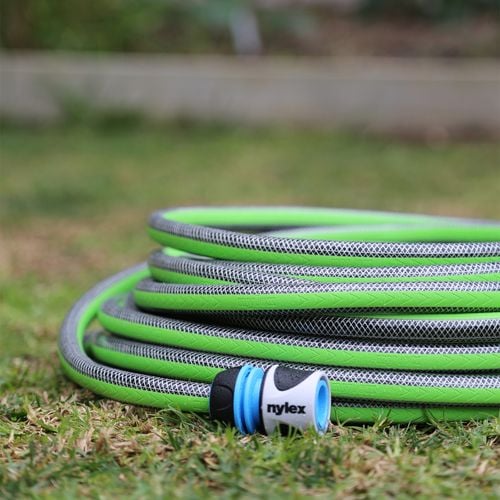 Close up of a green Nylex garden hose with signature branded blue and white tap fitting on end