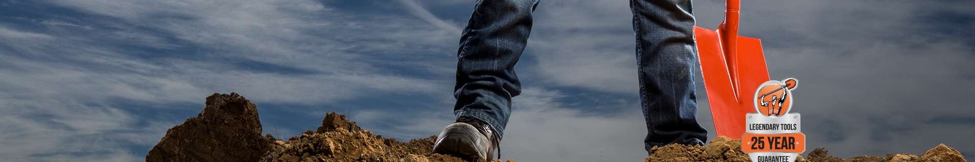 Tradie standing on pile of dirt.