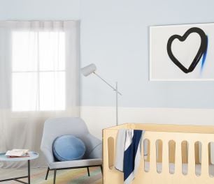 Baby's bedroom with cot, chair and table