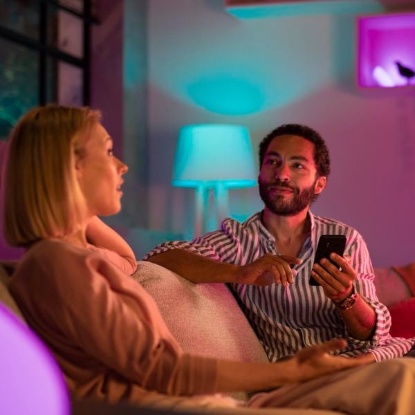 a couple on adjusting ambiance lighting on the phone