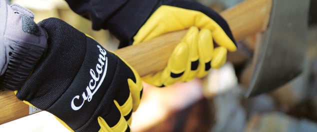 Person holding axe with gloves on