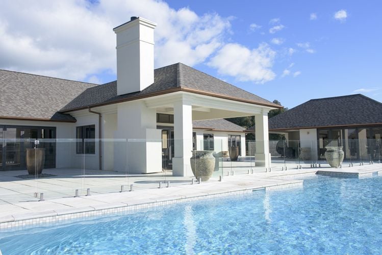 House exterior with tiles, pool and copper-coloured PVC gutters and drainage pipe