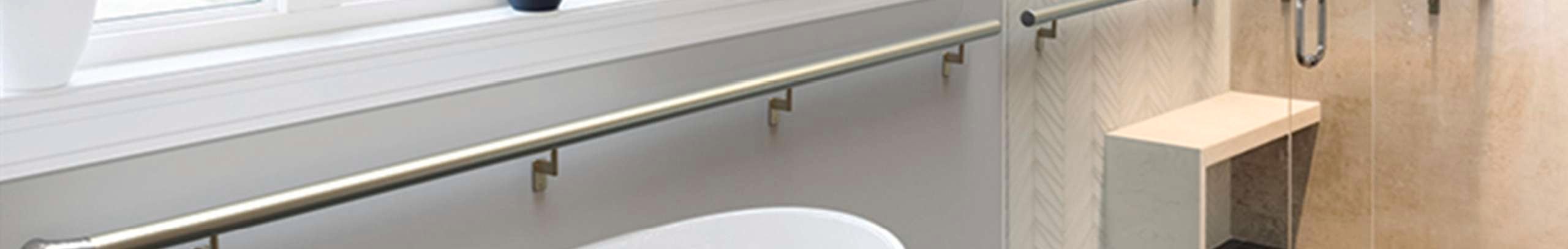 A modern bathroom with bathtub, tiled shower and railing