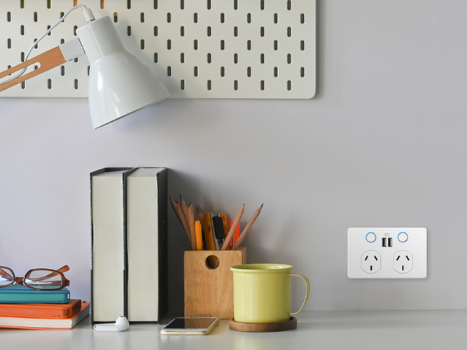 Smart modern power point with USB ports and illuminated, soft touch buttons located next to office desk.