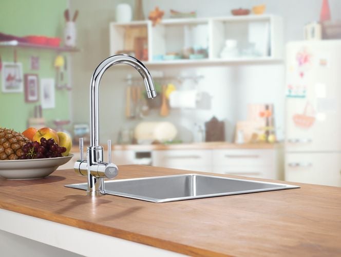 Kitchen benchtop with stainless steel sink and tapware