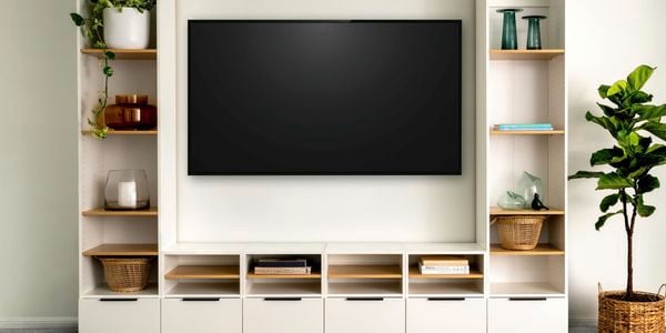 Lounge space with shelving unit and tv mounted in the middle.