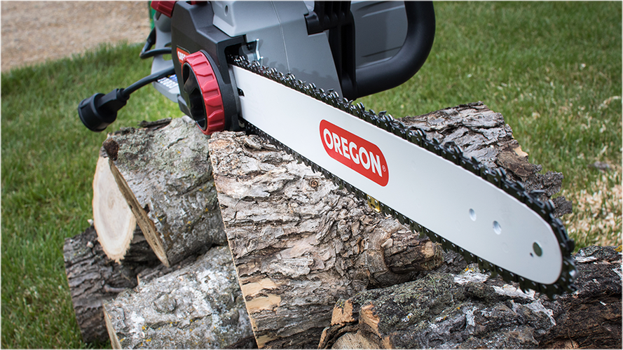 Chainsaw sitting on stack of logs