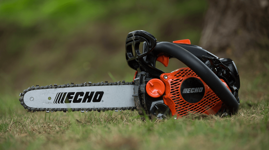 Chainsaw sitting on grass