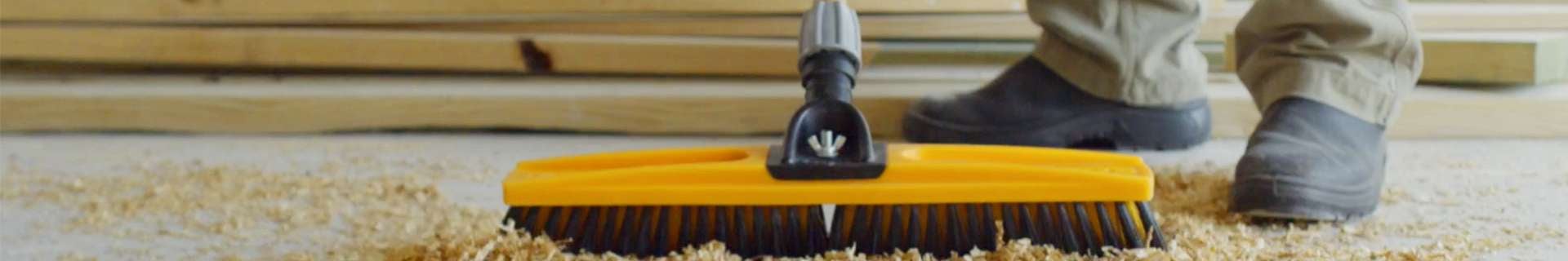 Broom sweeping sawdust.