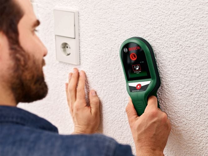 Man using wall scanner