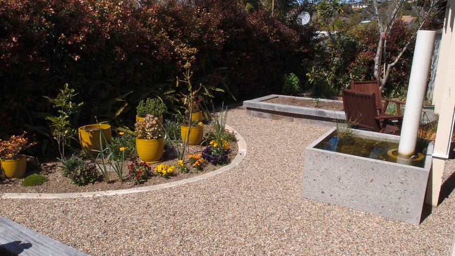 Path grade outdoor area with colourful pots and plants