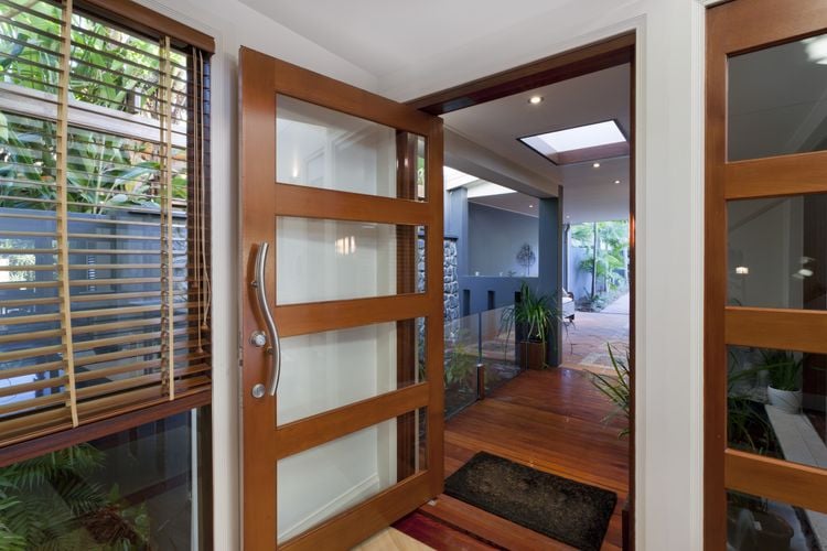 Entry into home with large timber and glass door
