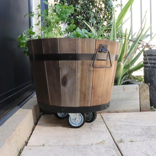 Planter barrel with wheels.