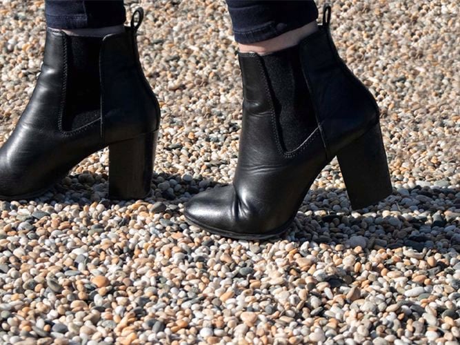 woman wearing heels on a paved way