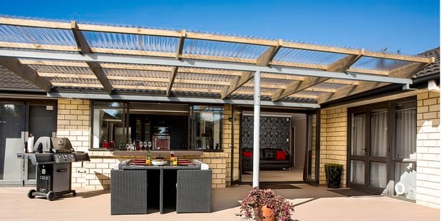 Outdoor entertaining area with outdoor structure and clear suntuf on top