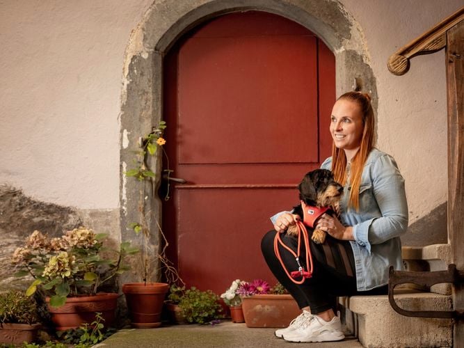 pet and owner sitting with the harness on 