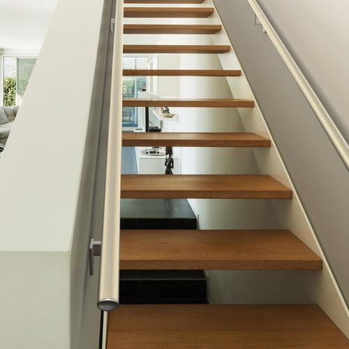 A modern staircase with timber steps and rails