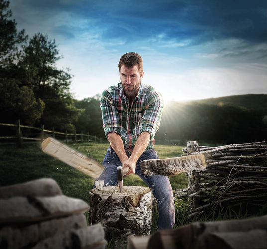 Man chopping firewood in half