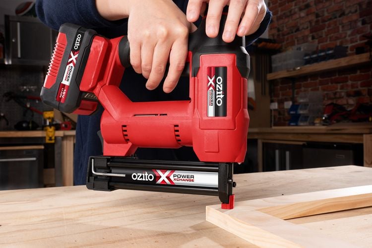 Person nailing a frame with a nail gun