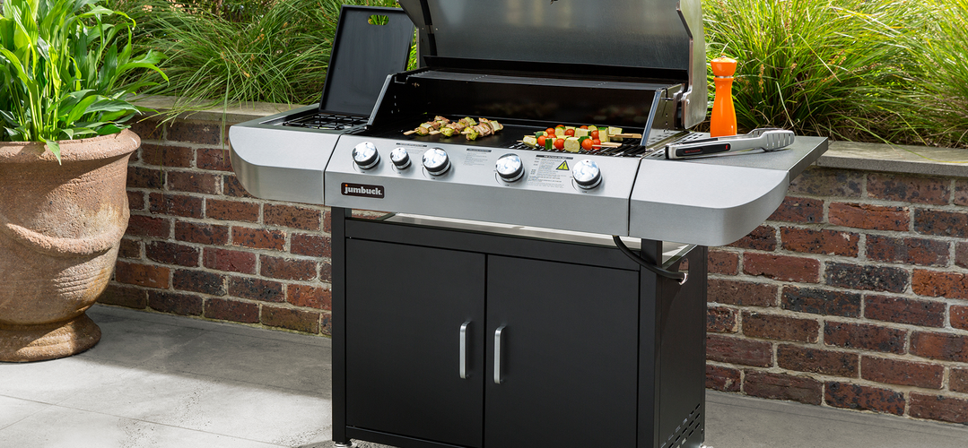 Skewered meats and vegetables cooking on a barbecue