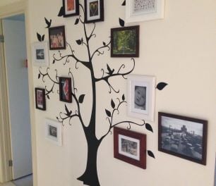 Pictures hung at the end of the branches of a wall print tree