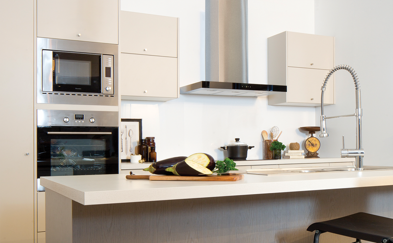 Kitchen with kitchen island, oven, stove and range hood