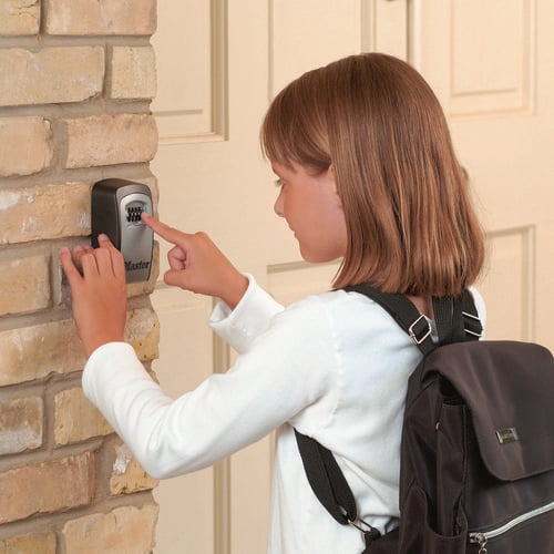 Girl entering code into key lock box
