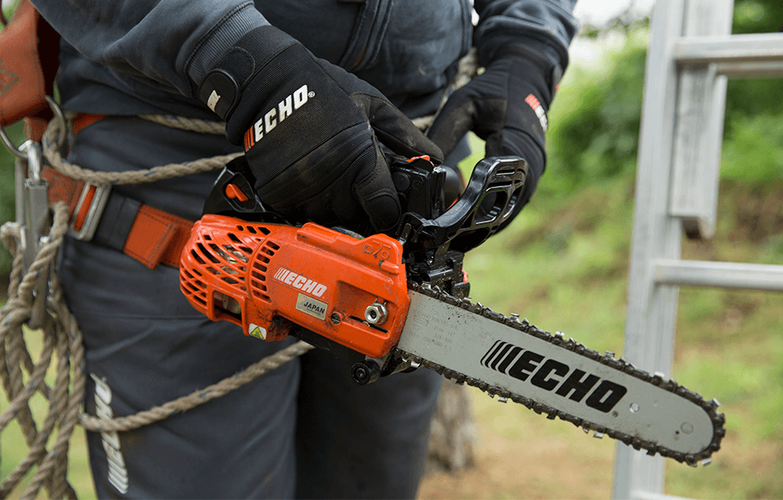 Person holding medium-sized chainsaw