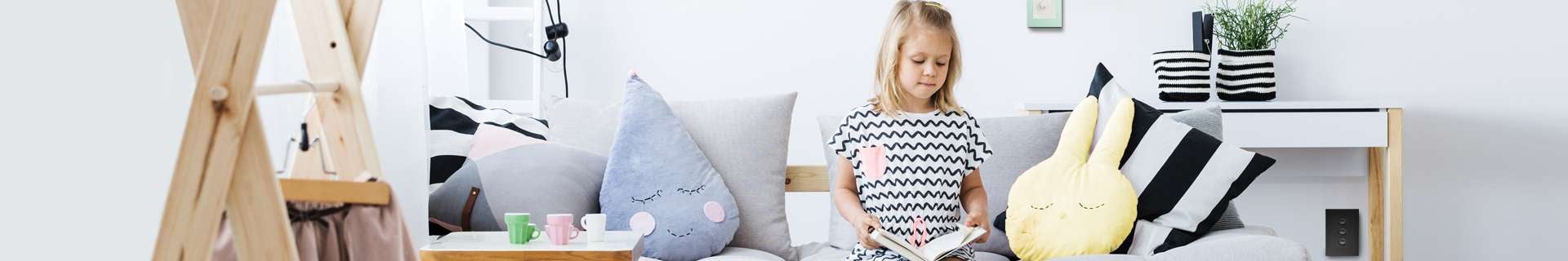 Girl sitting on couch reading a book