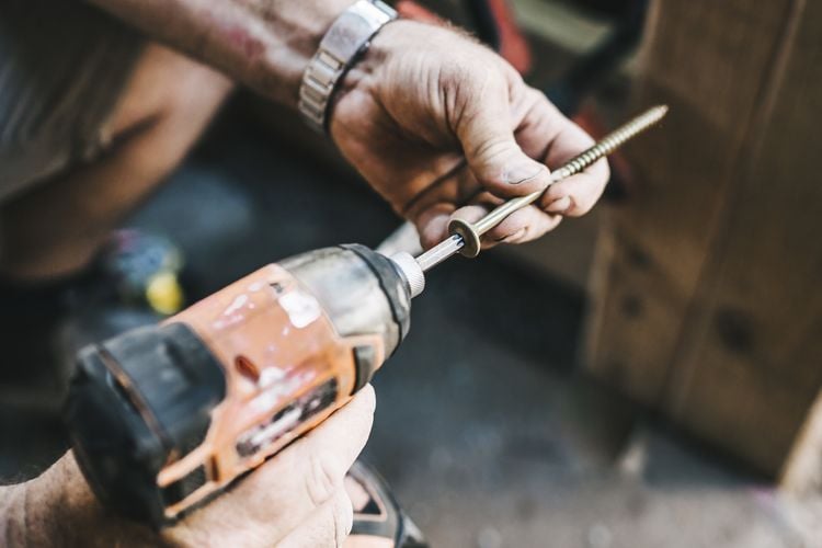 Screw being drilled into timber