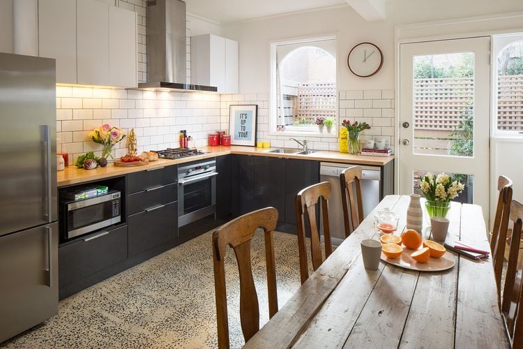 Kitchen with dark shelving and light timber benchtop