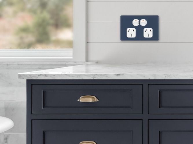 Midnight navy double power point on a bathroom wall.