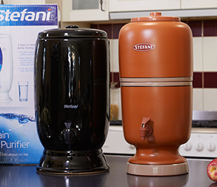Two water filters on a kitchen bench