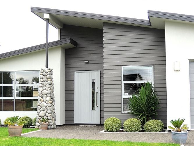 Front entryway to weatherboard home with light blue front door