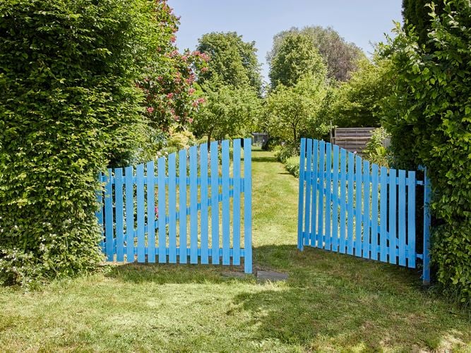 Finished
  result of a picket fence painted in baby blue