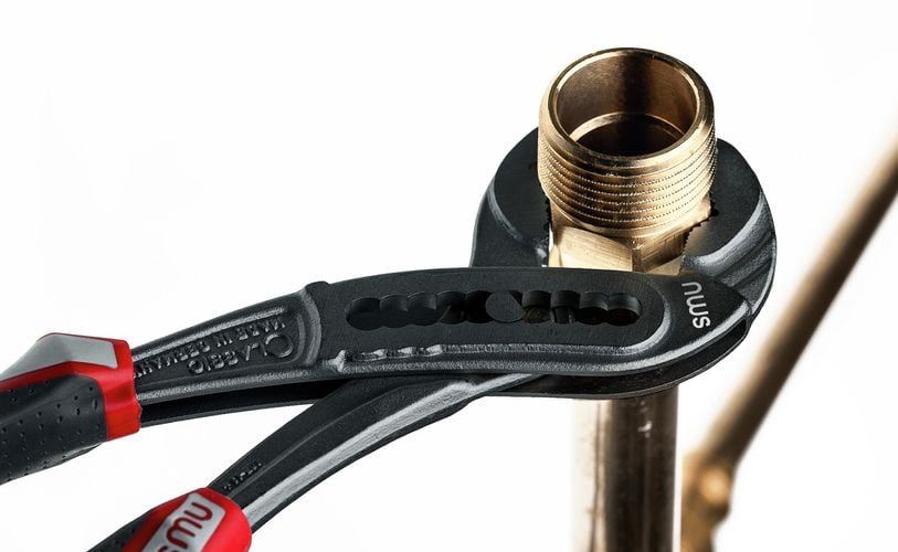 Handheld clamp holding brass fitting in place