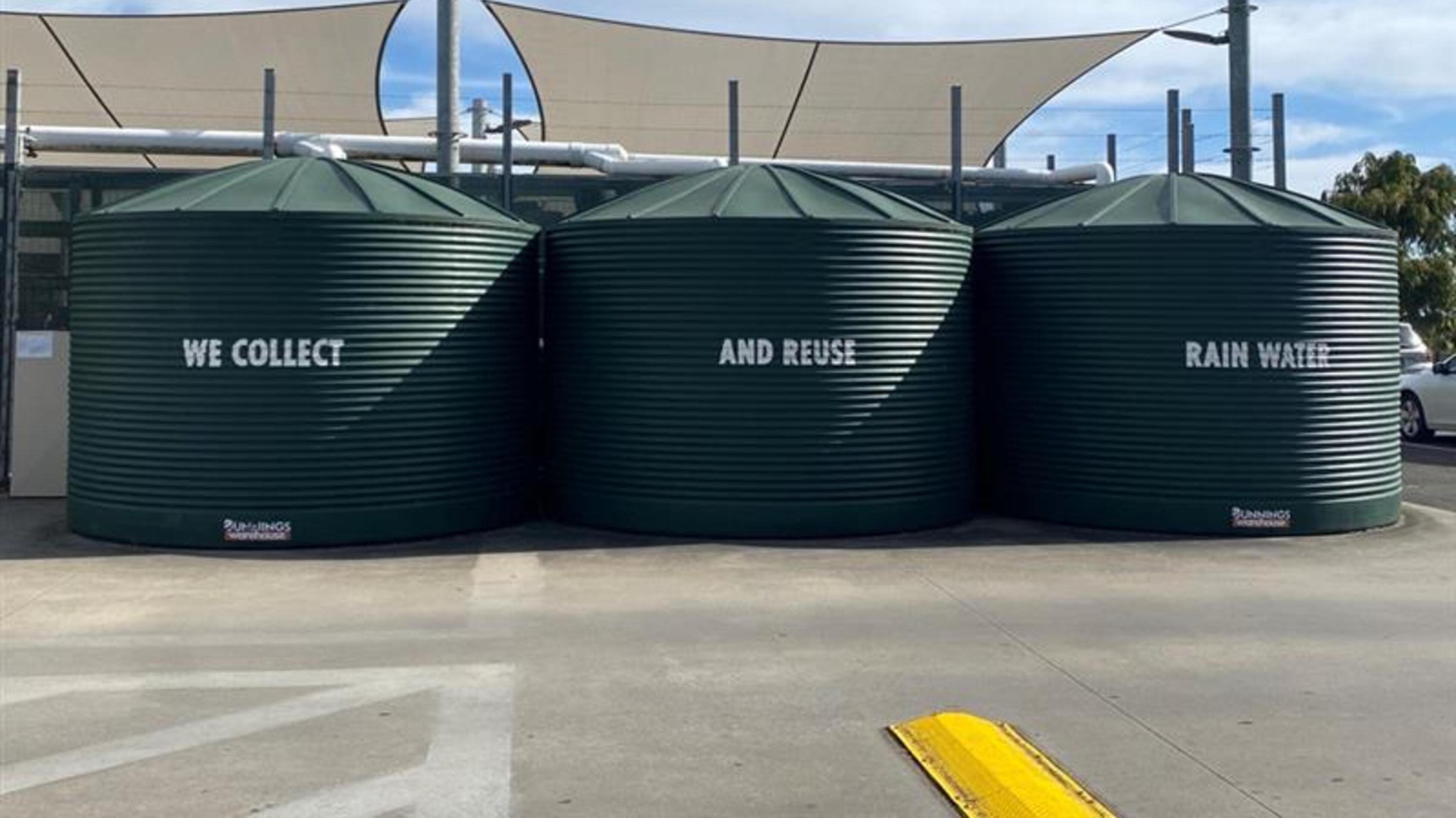three rain tanks on exterior of warehouse