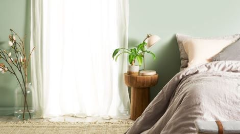Bedroom with bed and stool bedside table