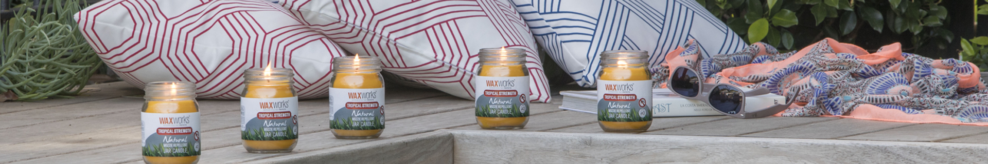 Outdoor table with citronella candles and outdoor cushions