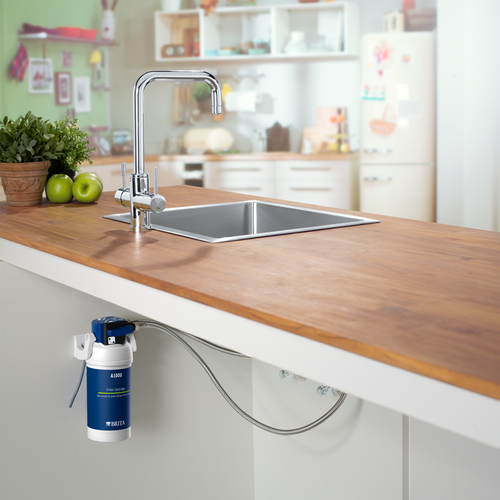 Kitchen benchtop with stainless steel sink and tapware