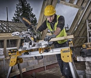 Person using circular saw to cut timber on a work trestle