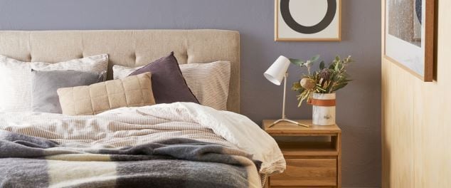 Bedroom with bed and bedside table and artwork