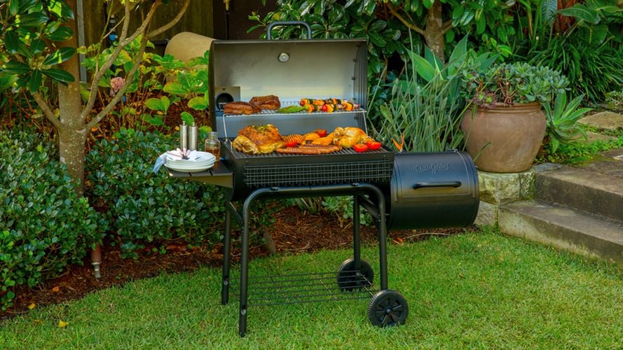 Barbecue full of cooked meats and vegetables