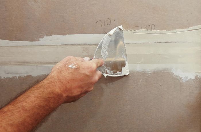 A spatula used to smooth plaster between two sheets of villaboard