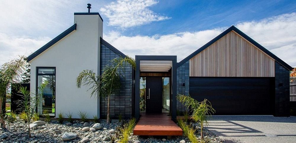 Front entryway to recently built home with timber decking and stone garden