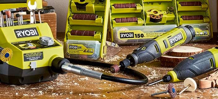 Ryobi Craft rotary tools spread out on a work table and hung on a pegboard.